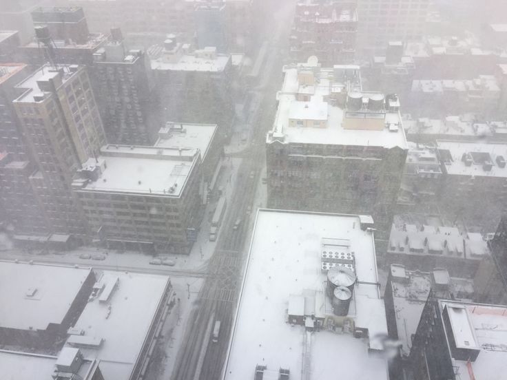 an aerial view of snow covered buildings in the city