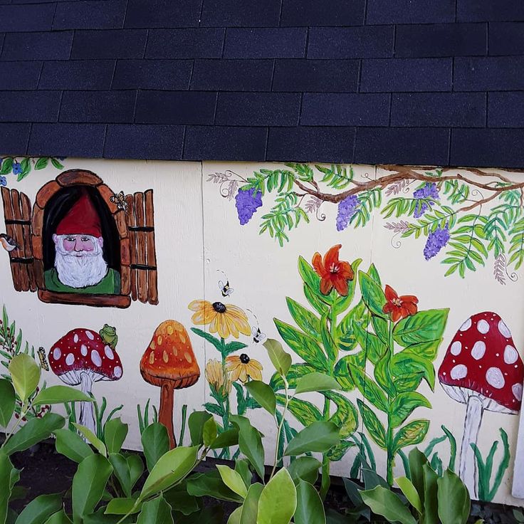 a painted garden wall with gnomes and mushrooms