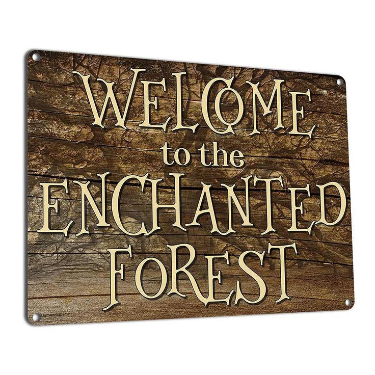 a wooden sign that says welcome to the enchanted forest