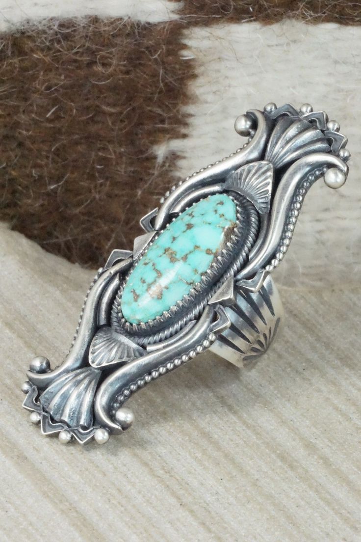 This Dry Creek turquoise and sterling silver ring was made by Navajo silversmith Derrick Gordon. The back is signed Derrick and stamped sterling.Size: 8.75Length: 2 1/2"Width: 1"Free shipping on all orders! We ship with USPS and always include tracking. All orders ship within a day of payment.Returns are accepted up to 30 days after you receive your order. Just send us a message. Our shop offers cash back or store credit. The item must be returned in new condition. Western Sterling Silver Turquoise Concho Ring, Western Sterling Silver Turquoise Ring With Patina, Western Sterling Silver Turquoise Ring, Collectible Western Style Turquoise Ring Stamped 925, Southwestern Stamped Turquoise Ring, Western Style Turquoise Ring With Sterling Silver Inlay, Western Style Turquoise Inlay Ring In Sterling Silver, Western Style Sterling Silver Turquoise Inlay Ring, Turquoise Wedding Rings