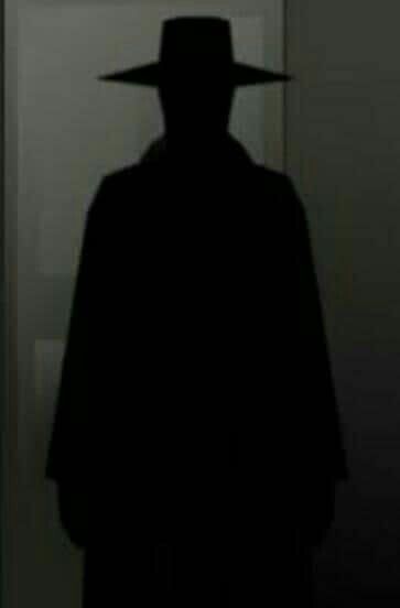 the silhouette of a man wearing a hat in front of a mirror with his shadow on it