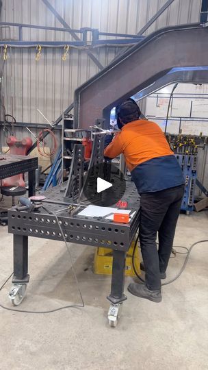 a man working on machinery in a factory