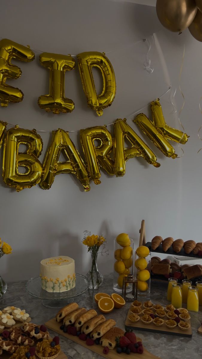 a table topped with lots of food and balloons