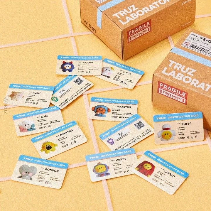 a group of cards sitting on top of a table next to a box with stickers