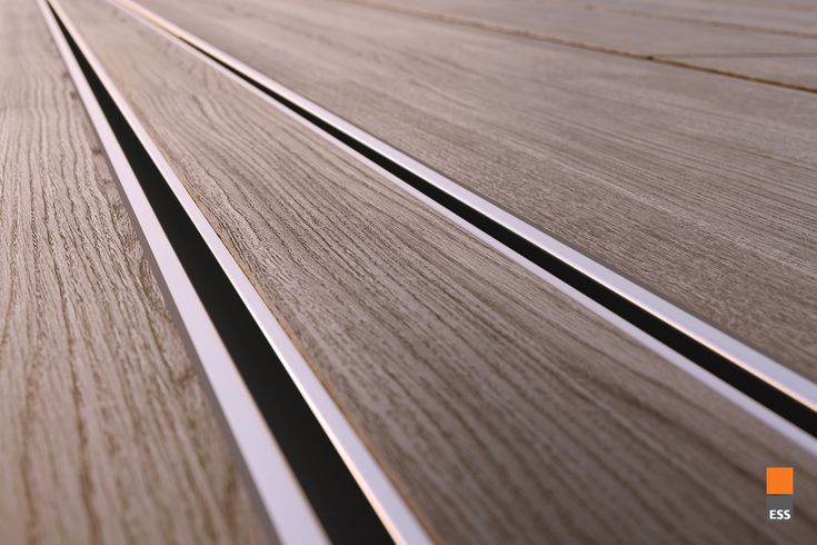 close up view of wooden flooring with metal lines on the bottom and side panels