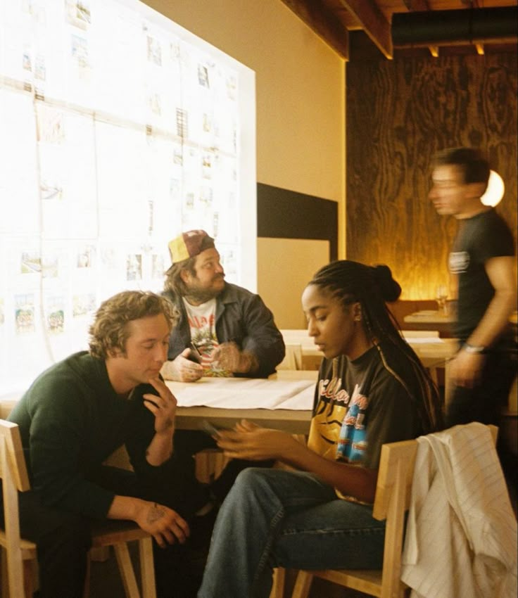 three men sitting at a table in a restaurant