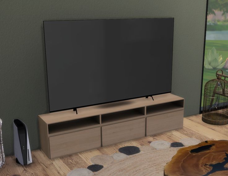 a large flat screen tv sitting on top of a wooden cabinet in a living room