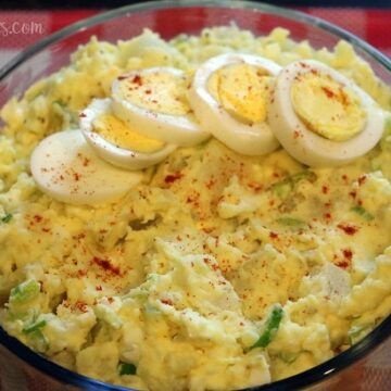 a bowl filled with eggs on top of a red and white checkered table cloth