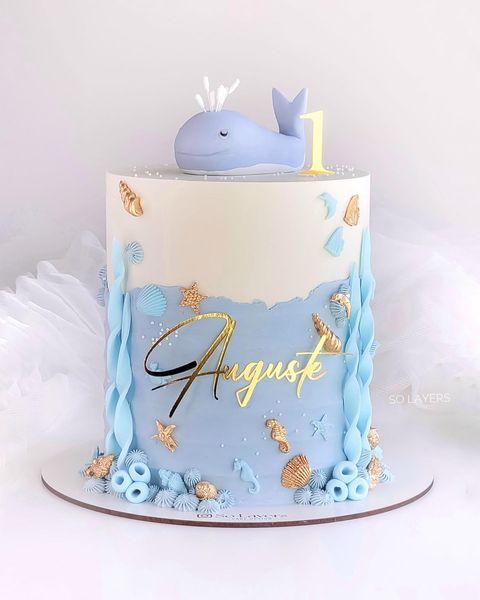 a blue and white cake with a whale on top