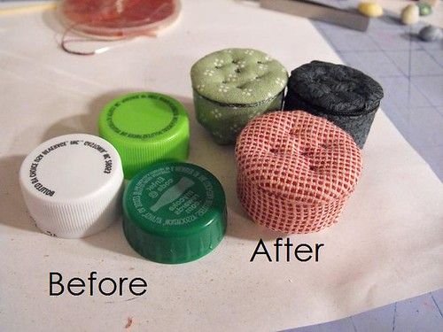 four different colored containers sitting on top of a white tablecloth next to each other