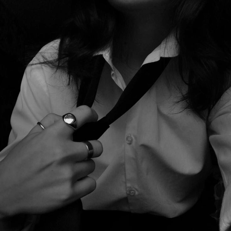 black and white photograph of a woman tying her tie