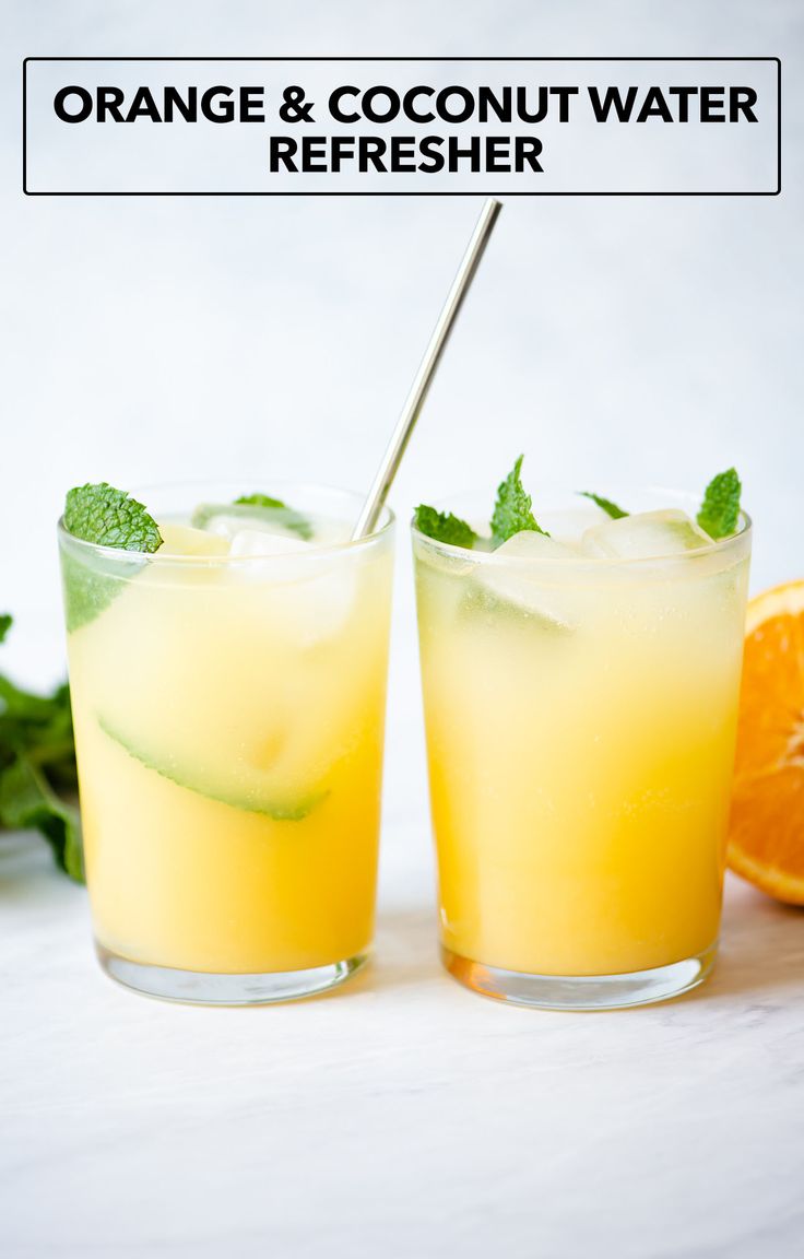 orange and coconut water refresher in glasses with mint garnish on the rim