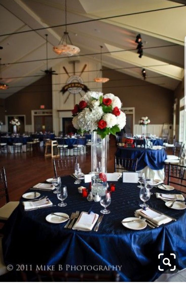 the tables are set with blue linens and white flowers