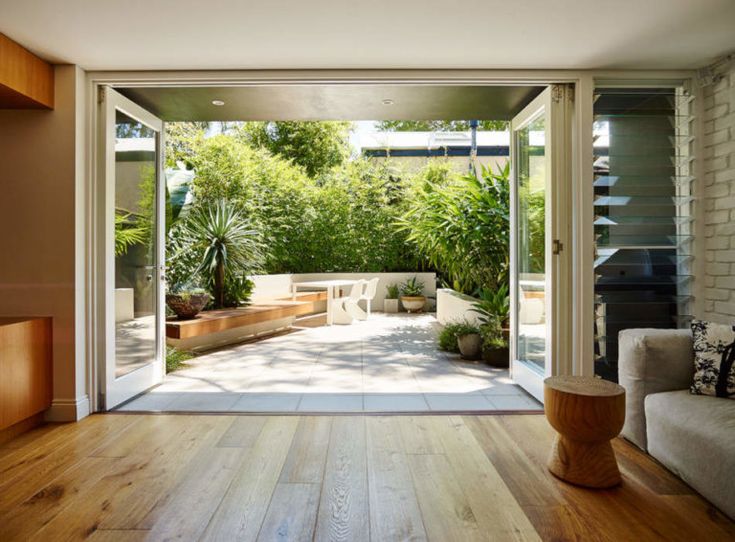 an open living room with wooden floors and sliding glass doors