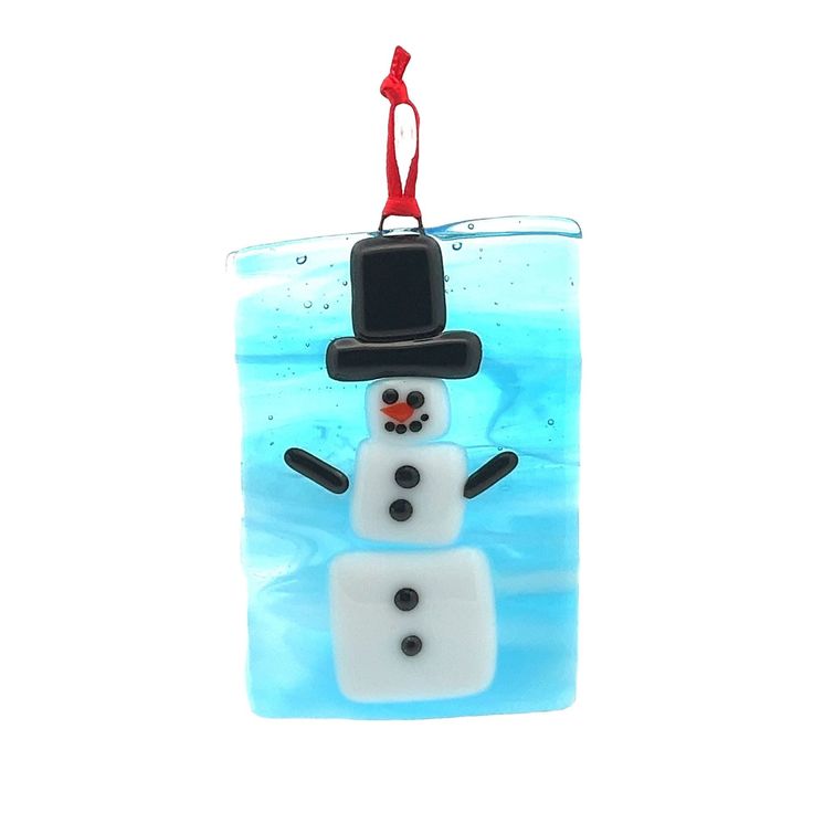 a glass ornament with a snowman on it