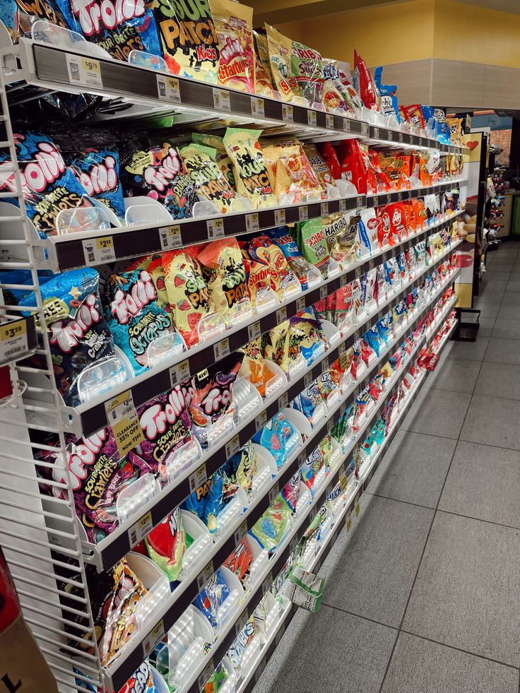 an aisle in a grocery store filled with lots of cereals and other snacks on display