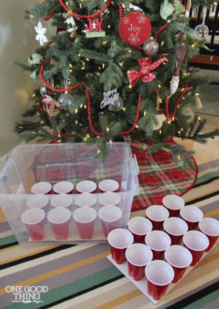 a small christmas tree with red cups in front of it