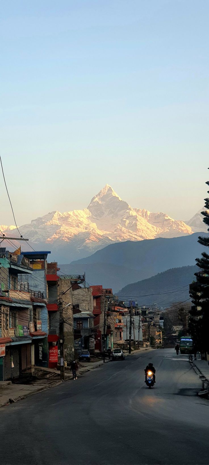 a city street with mountains in the background