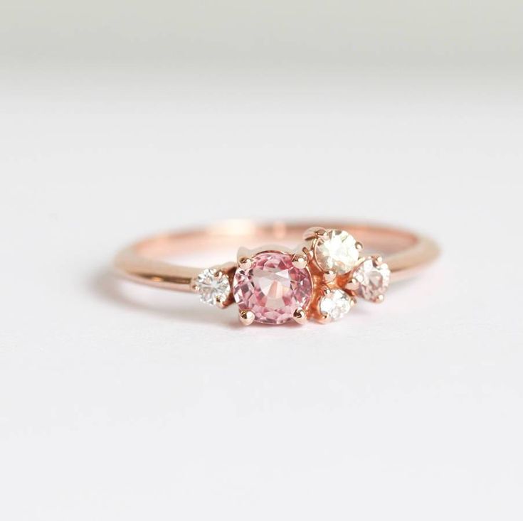 MADISON PEACH SAPPHIRE DIAMOND CLUSTER RINGThis delicate peach pink Sapphire and Diamond cluster ring will lift you up on any bad day - the sparkles are amazing and the blush tones are complimenting all skin tones.DETAILSMain Stone  Stone: Sapphire  Shape: Round  Color: Peach Pink  Measurements: 5.5x4mm Side Stones  Round White Diamond: 1.75mm (1)  Round White Diamond: 1.5mm (1)  Round Diamond: 2.5mm (1)  Round Sapphire: 2mm (1) Band  Style: Cluster  Material:  14k Gold: yellow, white, rose  18k Pink Zircon, Peach Sapphire, Sapphire Rings, Colored Engagement Rings, Princess Ring, Wedding Rings Rose Gold, Rose Gold Wedding Bands, Gold Wedding Rings, Diamond Cluster Ring