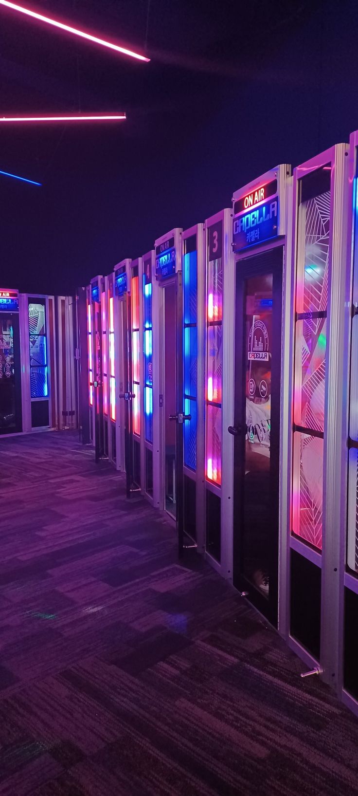 a row of vending machines sitting next to each other on top of a wooden floor