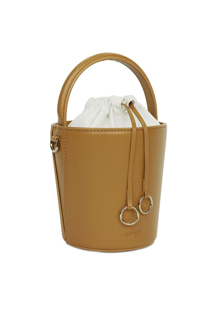 This CAFUNE Mustard Mini Bucket Basket, is probably the most structured bucket bag in the market, its cylindrical shape ensures a roomy interior. Wear it on your shoulder, cross-body, by the top handle or loop it in your arm.COLORMustardCOMPOSITION100% Italian Leather, Lining 100% Canvas DETAILS Drawstring top closure in canvas Cylindrical shapeDetachable adjustable strapBeige cotton lining Gold hardwareDIMENSIONS19 x 14 x 14 cm (H x W x D)0.35 kg (Weight)9.5 cm (Handle Drop)48-54 cm (Shoulder D Mini Basket, Mini Bucket Bags, Mini Bucket, Bucket Bags, Drawstring Top, Small Leather Goods, Silk Scarves, Leather Goods, Leather Accessories