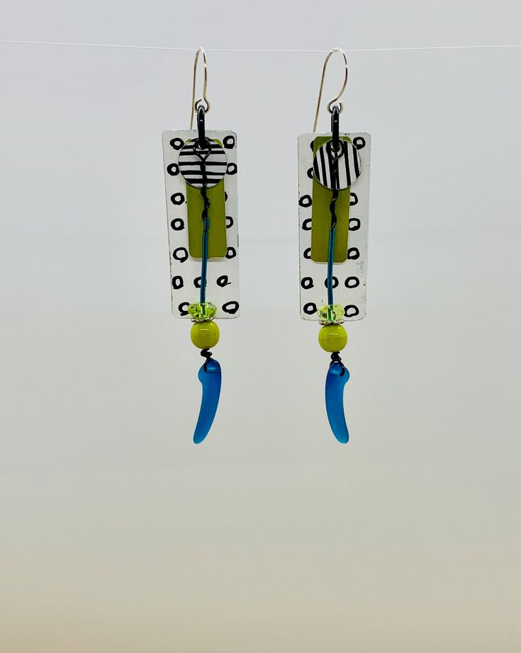 These super light weight earrings featured hand painted recycled aluminum in bold black and white with an accent of blue and chartreuse.   They are truly one of a kind!  As always, my ear-wires are 22 gauge sterling silver, hypoallergenic White Artsy Earrings With Ear Wire, Artsy White Earrings With Ear Wire, Artsy Black Earrings With Ear Wire, Bold Handmade Blue Earrings, Bold Blue Handmade Earrings, Handmade Black Contemporary Earrings, Contemporary Handmade Black Earrings, Artistic Turquoise Earrings With Ear Wire, Artistic Blue Earrings With Ear Wire