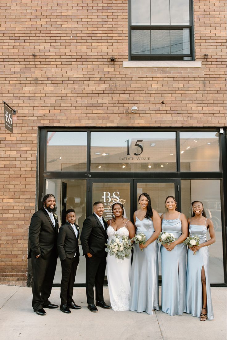 a group of people standing in front of a building