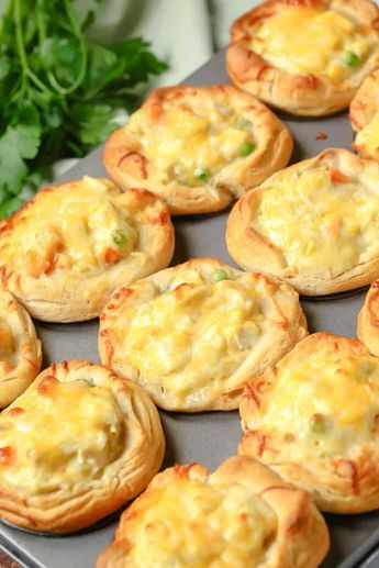 there are many small pies on the tray ready to be baked in the oven