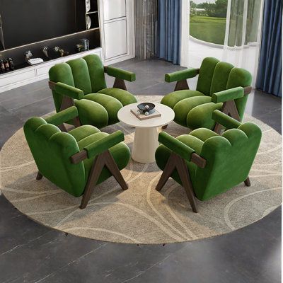 a living room filled with green chairs and a white table