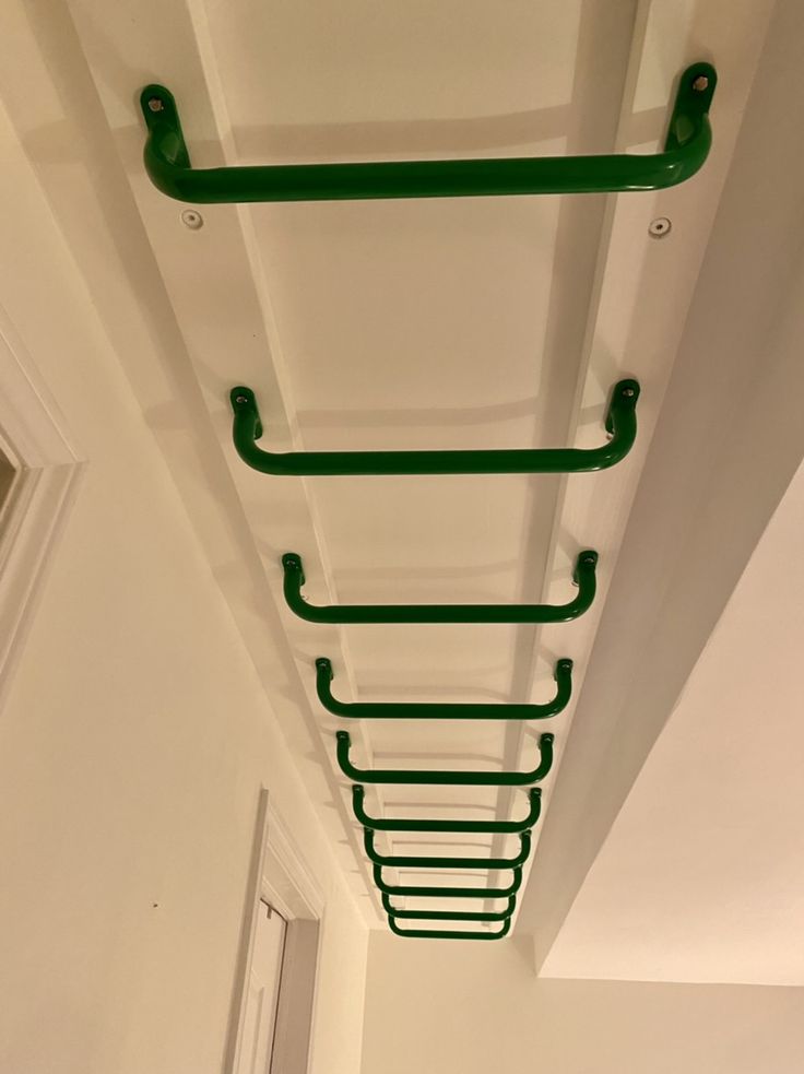 the ceiling is painted white and has green handles