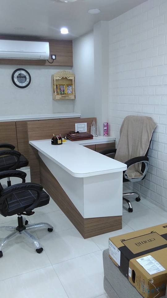 an office with two chairs and a desk in the middle, next to boxes on the floor