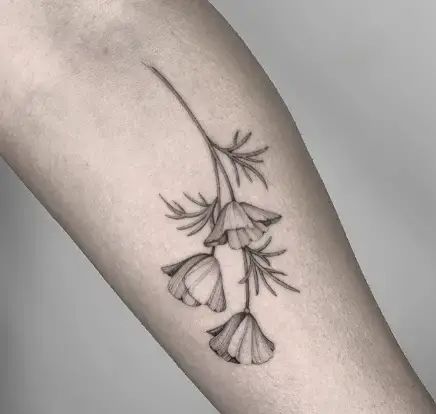 a tattoo on the arm of a woman with flowers