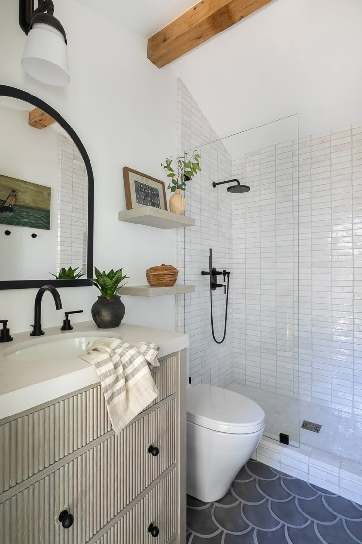 a bathroom with a sink, toilet and shower in it's center piece is shown