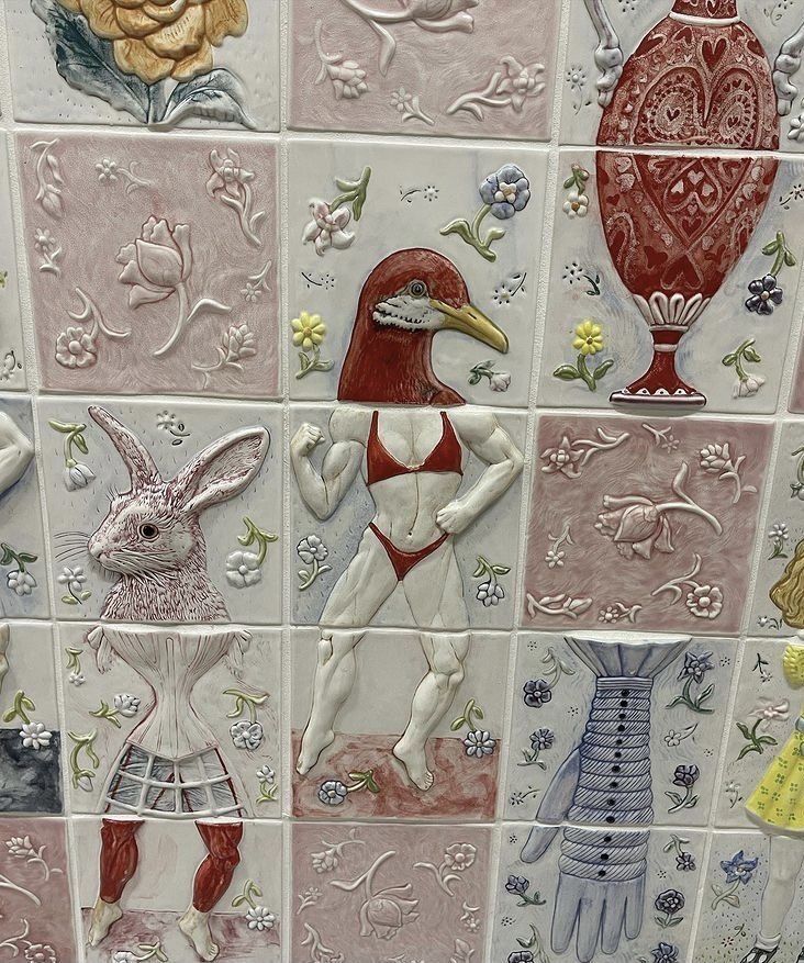 a tiled wall with many different designs on it