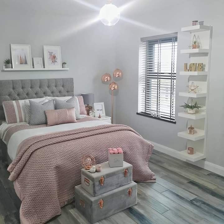 a bedroom with white walls and pink bedding