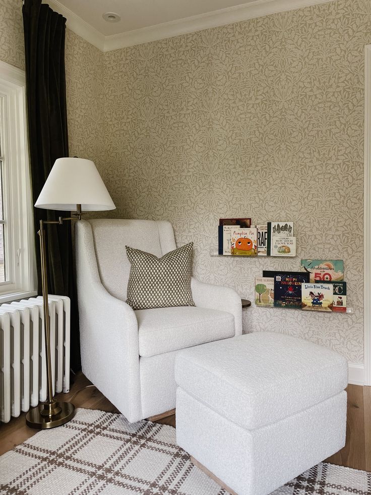 a white chair and ottoman in a living room with wall papered walls behind the radiator