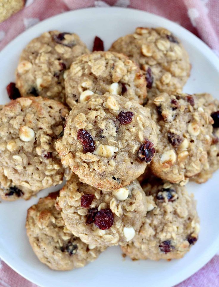 oatmeal cookies with cranberries and nuts on a white plate