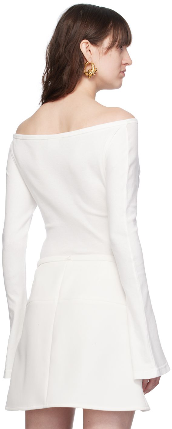 Cotton jersey bodysuit. Rib knit trim throughout. · Off-the-shoulder construction · Boatneck · Logo embroidered at chest · Cutout at front · Press-stud fastening at bottom · Flared cuffs Supplier color: Heritage white Elegant Fitted Off-shoulder Bodysuit, Elegant Off-shoulder Fitted Bodysuit, Fitted Long Sleeve Top With Structured Shoulders, Fitted Top With Structured Shoulders And Long Sleeves, Classic Fitted Tops With Structured Shoulders, Fitted White Tops With Structured Shoulders, Press Studs, White Shop, Boat Neck