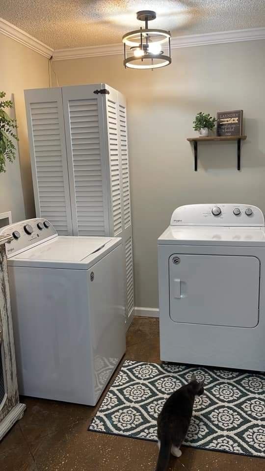 a white washer and dryer sitting next to each other in a room with a rug on the floor