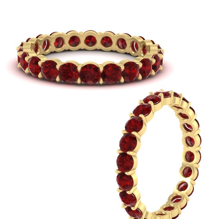 a gold ring with red stones on the inside and outside, set against a white background