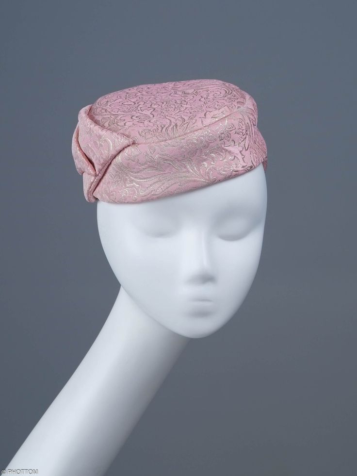 Jackie is a chic, elongated button-shape fascinator completed with a large charismatic bow. The mini hat sits comfortably on the top of your head and should be worn slightly towards right. This  headpiece is hand formed and sewed, making it an exclusive design. This artisan cocktail fascinator will appeal most when worn to complement classic outfits comprising cream, gold or shades of pink. *Handmade item *Style: Jackie *One size fits all *Fabric: pink silk, gold jacquard *Ships worldwide from Poland *More products available on www.joremi.co.uk For the customisation option, please contact me via 'Request a custom order' button at the top of the page. Please note that due to the nature of this handmade artisan headwear, making a second entirely identical item is not possible. We can discuss Mini Hat, Cocktail Hat, Gold Fabric, Fascinator Hats, Beautiful Hats, Classic Outfits, Pink Silk, Hat Making, Handmade Artisan