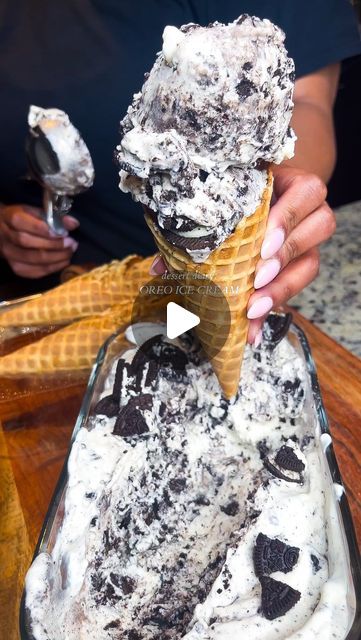 an ice cream sundae is being held up