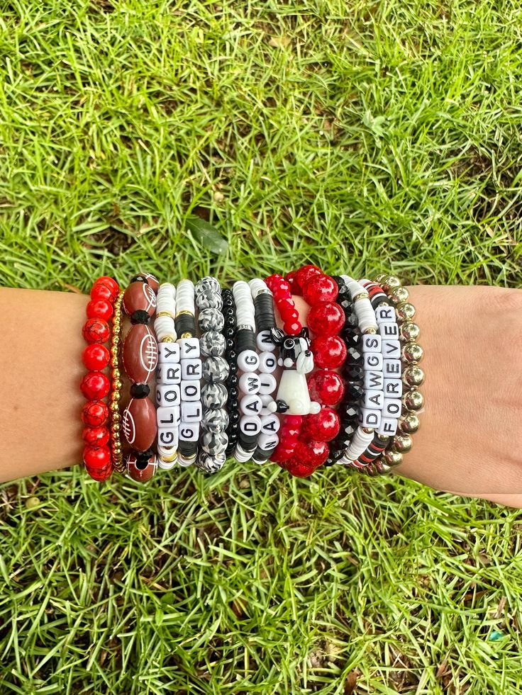 Georgia game day bracelet stack. 5 bracelet strands included in one stack. Multi material beads on elastic cord. One size fits all. Prices are based on bead material and size. Adjustable Red Stacked Beaded Bracelets, Adjustable Stacked Red Beaded Bracelets, Adjustable Stacked Black Beaded Bracelets, Adjustable Multicolor Beaded Bracelets For Game Day, Game Day Black Wristband With Letter Beads, Black Team Spirit Adjustable Beaded Bracelets, Black Adjustable Beaded Bracelets Team Spirit Style, Adjustable Team Spirit Stretch Bracelet For Game Day, Black Adjustable Beaded Bracelets For Team Spirit