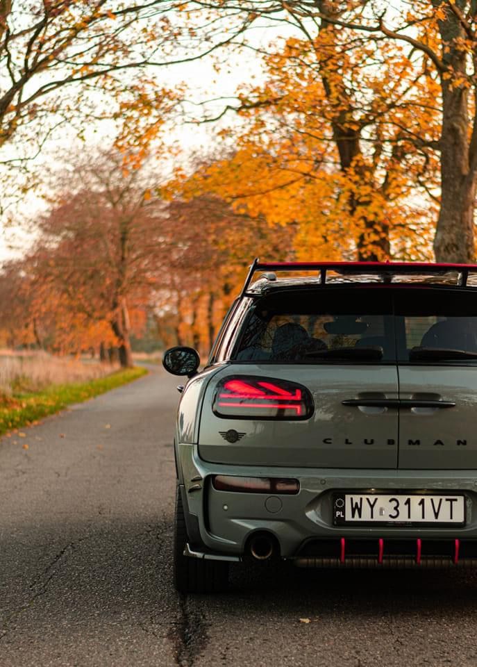 a car parked on the side of a road near trees