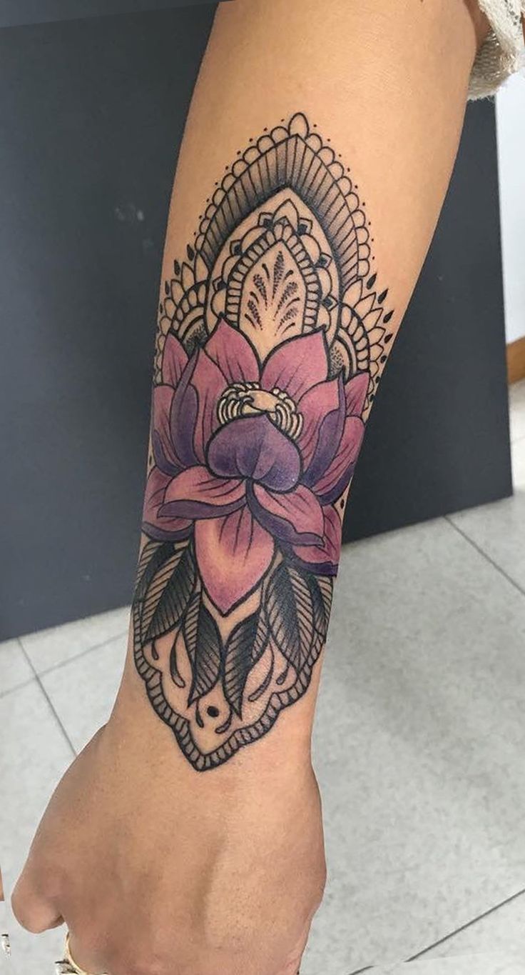 a woman's leg with a flower tattoo on it