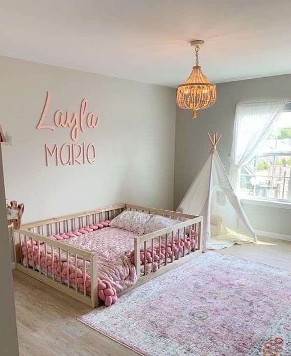 a baby's room is decorated in pink and gray colors with a teepee tent