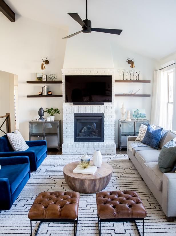 a living room filled with furniture and a flat screen tv mounted on the wall above a fireplace