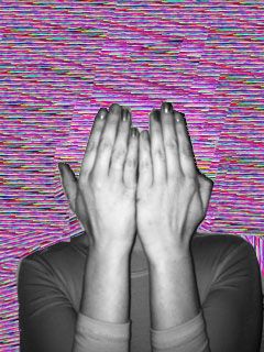 a woman covering her face with both hands in front of a colorful wallpaper background