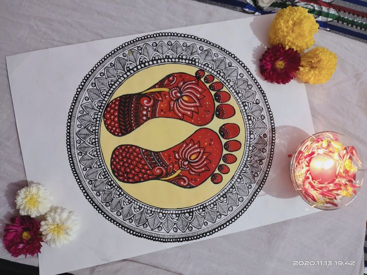 a paper with an image of two women on it next to some flowers and a candle