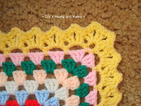 a crocheted square is sitting on the floor